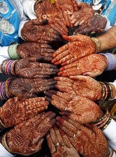 many people are holding their hands together to show off their hendigns and jewelry