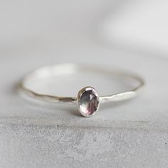 Tiny skinny stackable ring with beautiful bi-color Tourmaline stone. It is made with a skinny but sturdy band, which allows you creating mind-blowing stacking sets! The ring is ideal for everyday wear and it will also look amazing with a festive dress. The ring is 0,8-0,9 mm thick and looks very dainty on the finger. Choose the stone you wish to get (see the pictures) and the metal for the ring (sterling silver or 9k gold). If you want 14k gold option, please contact me for the price quote. If y Dainty Oval Stackable Birthstone Ring, Festive Dress, Dainty Rings, Tourmaline Stone, Price Quote, Oval Rings, Tourmaline Ring, October Birthstone, Stackable Ring