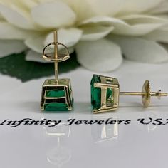 "These earrings are radiant cut lab created green emerald studs, 14k yellow gold #6228 -Approximate total carat weight: 3.50ctw diamond equivalent -Stone Size: approx. 1.75ct each diamond equivalent -Gem Type: emerald -Stone Shape: radiant cut 7x7mm each -Stone Clarity: VS2 -Stone Color: green -Moh's Scale: 8.5 Hardness -Metal Type and Purity: 14k yellow gold -Setting: 4 prong basketsetting -Backing: screw back (earring backs are subject to change due to availability) -Country of Manufacturing: Green Prong Setting Earrings In Fine Jewelry Style, Green Emerald Earrings With Prong Setting, Emerald Cut Green Gemstone Earrings, Classic Green Diamond Cut Earrings, Emerald Cut Green Earrings, Green Earrings For Anniversary, Gold Emerald Cut Emerald Earrings, Gold Emerald-cut Emerald Earrings, Gold Emerald-cut May Birthstone Earrings