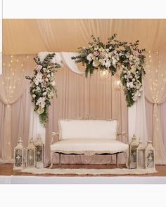 a white couch sitting under a canopy covered in flowers