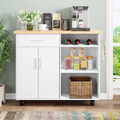 a white cabinet with some items on it and a potted plant next to it