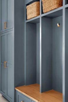 a blue cupboard with two baskets on it