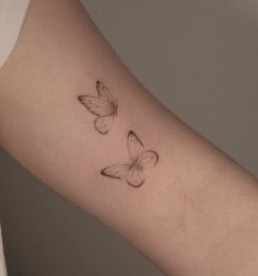 a woman's arm with two butterflies on it