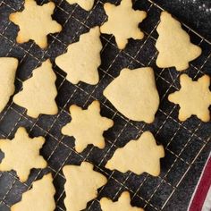 some cookies are on a cooling rack and ready to be cut into christmas tree shapes