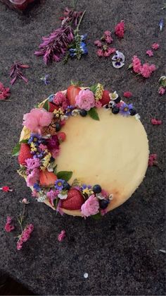 a piece of cake with flowers on it sitting on the ground next to confetti