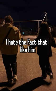 two people walking down the street at night with text that reads i hate the fact that i like him