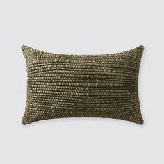 an olive green pillow on a white background