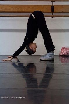 a man is doing a handstand on the floor