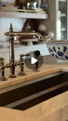 a kitchen sink with an old fashioned faucet and bowl on the counter top