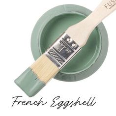 a paint brush with the words french esyshell on it in front of a green bowl