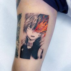 a person with a tattoo on their arm that has an anime character in the background