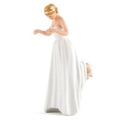 a figurine of a woman in a white dress