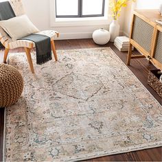 a living room area with a rug, chair and window