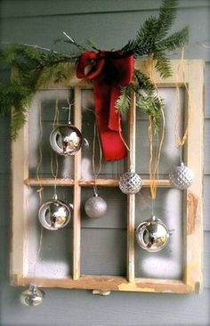 an old window is decorated with christmas ornaments