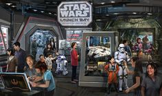 a group of people standing next to each other in front of star wars exhibit displays