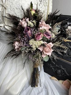 a bouquet of flowers sitting on top of a bed