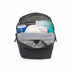 an open backpack filled with toiletries on top of a white background and the contents in it