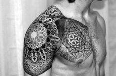 black and white photo of a man's half sleeve with geometric designs on it