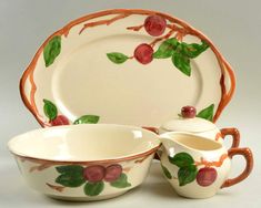 an image of a set of dishes with cherries on them