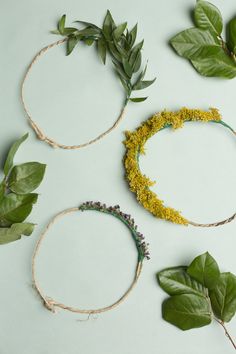 four different types of wreaths with flowers and leaves around them on a white surface