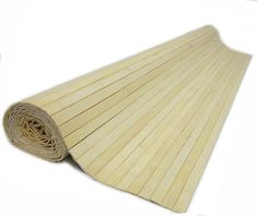 a roll of bamboo paper is laying on the white floor with it's end rolled up