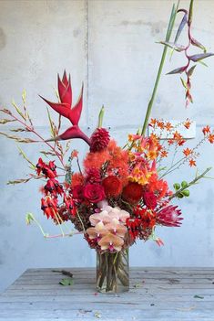 a vase filled with flowers on top of a wooden table