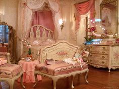 an ornate bedroom with pink and white decor