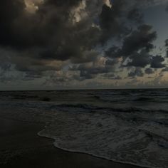 dark clouds over the ocean on a cloudy day