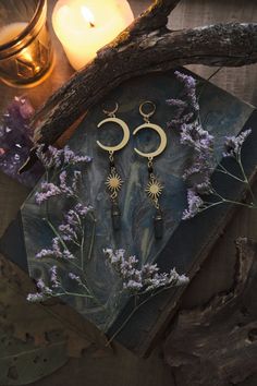 * Perfect gift for all the Moon Lovers! Long statement Moon and Stars earrings which will give your outfit a mystical touch. Super lightweight! * These beautiful dangling earrings have a witchy, bohemian feel to them, and are decorated with real Aura Quartz Crystal points.  * Stainless steel! * The total length of the earrings will vary a little bit as each Quartz crystal is different, but approximately 10 cm (aprox 4 inches), hook included.   * They come in a pretty little burlap pouch 🖤 * Find the matching necklace here! https://www.etsy.com/listing/1567590788/moon-and-sun-necklace-with-aura-quartz Mystical Crescent Earrings For Pierced Ears, Mystical Moon Shaped Brass Earrings, Mystical Moon-shaped Brass Earrings, Mystical Moon Phase Dangle Earrings, Mystical Moon-shaped Pierced Earrings, Mystical Moon Phase Earrings For Festivals, Mystical Metal Earrings For Festivals, Mystical Moon Charm Dangle Crystal Earrings, Witchy Dangle Earrings For Festival