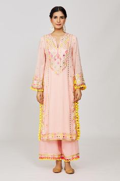 Pink long kurta with sequin, mirror, thread embroidery in geometric pattern. Paired with palazzo and dupatta.
Components: 3
Pattern: Embroidery
Type Of Work: Mirror, thread, sequin, geometric
Neckline: Notched
Sleeve Type: Full sleeves
Fabric: Kurta: Viscose, Palazzo: Linen Satin, Dupatta: Chiffon
Color: Pink
Other Details: 
Pompom and tassel border
Sheer dupatta
Embroidery on palazzo hem
Occasion: Sangeet - Aza Fashions Pink Sequined Kurta For Festivals, Bohemian V-neck Kurta With Mirror Work, Pink Resham Embroidery Mulmul Palazzo Set, Fitted Pink Kurta With Embroidered Border, Pink Kurta With Embroidered Border, Pink Semi-stitched Straight Kurta Embroidered Fabric, Types Of Work, Full Sleeve, Aza Fashion