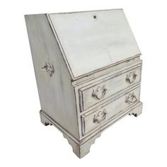 an old white wooden desk with drawers