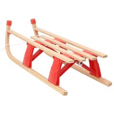 a wooden sled with two red poles attached to it