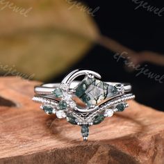 a close up of a ring on top of a piece of wood with an image of a bird