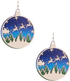 a pair of earrings with santa on a sleigh in the sky and trees