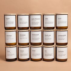 twelve jars of honey sit in front of a tan background with the label on each jar