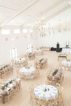 a large room with tables and chairs set up for a formal function in the center