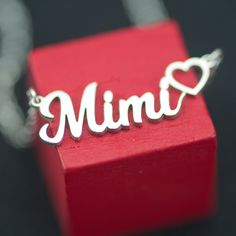 "The dainty Mimi Script Necklace features the word \"Mimi\" in custom script font and a cute Heart.  It sits beautifully on the neckline and looks stunning, alone or layered. It is the perfect gift for a Mimi for Mother's Day, Birthday, or Christmas.  The personalized dainty Mimi Necklace comes in three different lengths, 16, 17, and 18 inches, with an inch extension length. Features 5 to 5.5 mm lowercase letters. The length includes \"the Mimi\"." Mimi Necklace, Script Necklace, Magnetic Latch, Appreciate Life Quotes, Premium Jewelry, Drop Down List, Gift For Grandma, Cute Heart, Cute Necklace