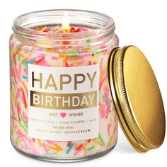 a jar filled with sprinkles and a candle