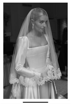 a woman wearing a wedding dress and veil