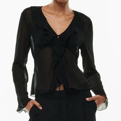 This Is A V-Neck Blouse With Ruffled Edges And A Tie Closure. It’s Made With Fte Chiffon Lightweight, Semi-Sheer Fabric With An Ethereal Drape. This Version Is Made From 100% Recycled Materials. Features Unlined For A Sheer Look Materials & Care Content: 100% Recycled Polyester Care: Machine Wash Imported Fit: Classic Follows Your Contours With A Little Room Length: Waist Intended To Hit Between The Waist And High Hip Bust 30 1/2 In Waist 22 1/2 In Spring V-neck Blouse For Night Out, Sheer Fitted V-neck Blouse, Chic Fitted V-neck Top For Night Out, Fitted Elegant V-neck Top For Party, Elegant Formal V-neck Top, Fitted V-neck Top For Spring Party, Formal V-neck Blouse With Ruffles, V-neck Ruffle Blouse For Night Out, Spring Viscose V-neck Top