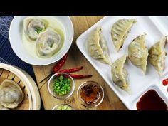 dumplings and sauces are sitting on the table