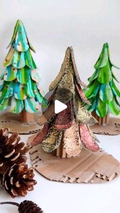 paper plate christmas trees with pine cones on the side and one is made out of cardboard