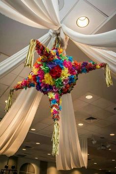 a star made out of flowers hanging from the ceiling