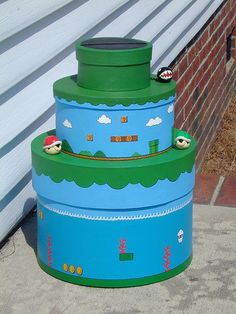 a three tiered cake made to look like mario kart on the side of a building