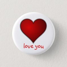 a white button with a red heart on it that says i love you in the center