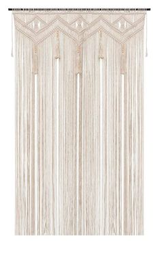 a white curtain with fringes hanging from it