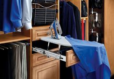 an ironing board is sitting on top of a cabinet