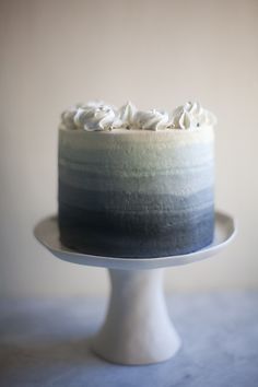 a cake with white frosting sitting on top of a plate