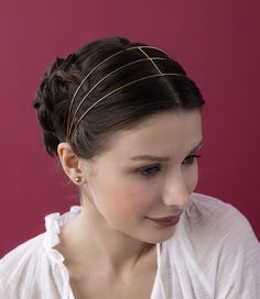 The Petite Saint Germaine Headband is here! Stemming from out best selling headband, the petite version is comprised of three layers of lightweight gold, demonstrating the versatility of simple elegance and ultimate fierceness. This artful construction encapsulates your hair in 14k gold plated bands as light as air. *As Seen on Emily in Emily in Paris, Season 4*Available in 14K Gold & Silver. Measures 2” in width. Pairs beautifully with our Saint Germaine Bun Cage. Gold Headband For Spring Season, Traditional Gold Headband Headpiece, Minimalist Gold Headband, Elegant Adjustable Gold Headband, Epona Valley, Gold Beaded Headband, Bridal Handbags, Rose Vines, Silver Headband