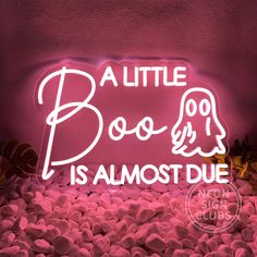 a pink neon sign that says,'a little boo is almost duee '